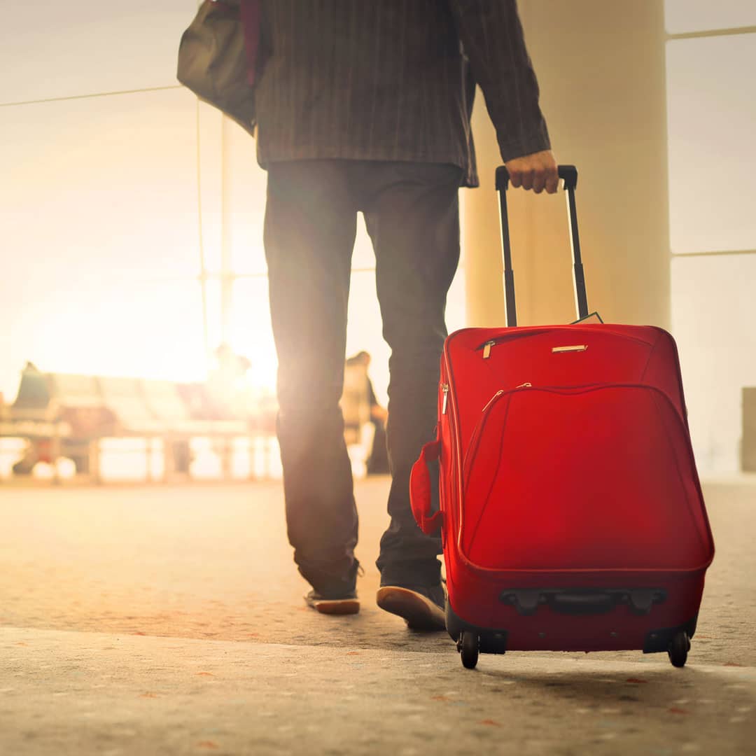 Man pulling travel suitcase